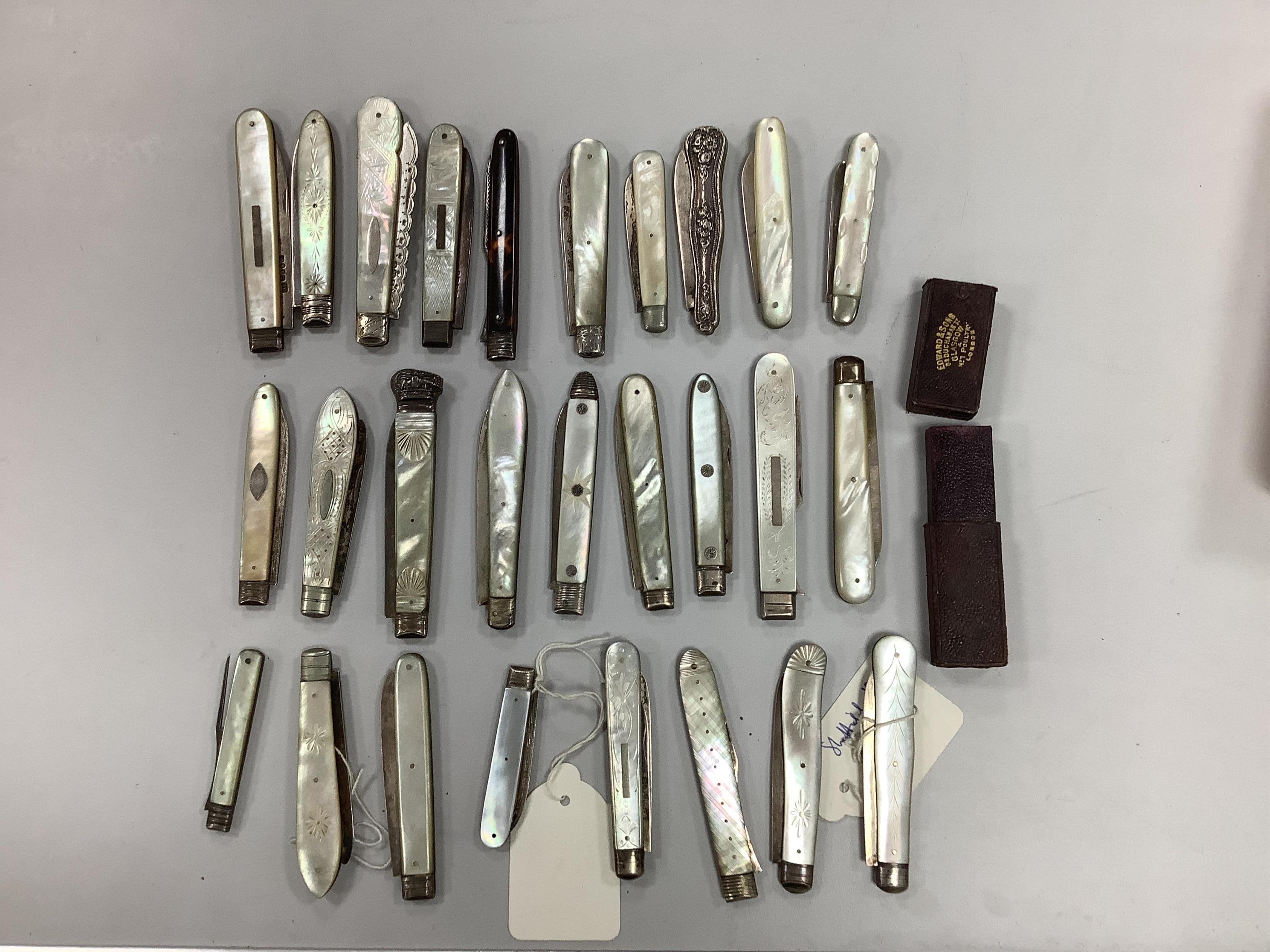 A collection of twenty two assorted mainly Victorian mother of handled silver fruit knives, one with leather case, together with a similar sterling knife and four Georgian silver travelling forks, three with mother of pe